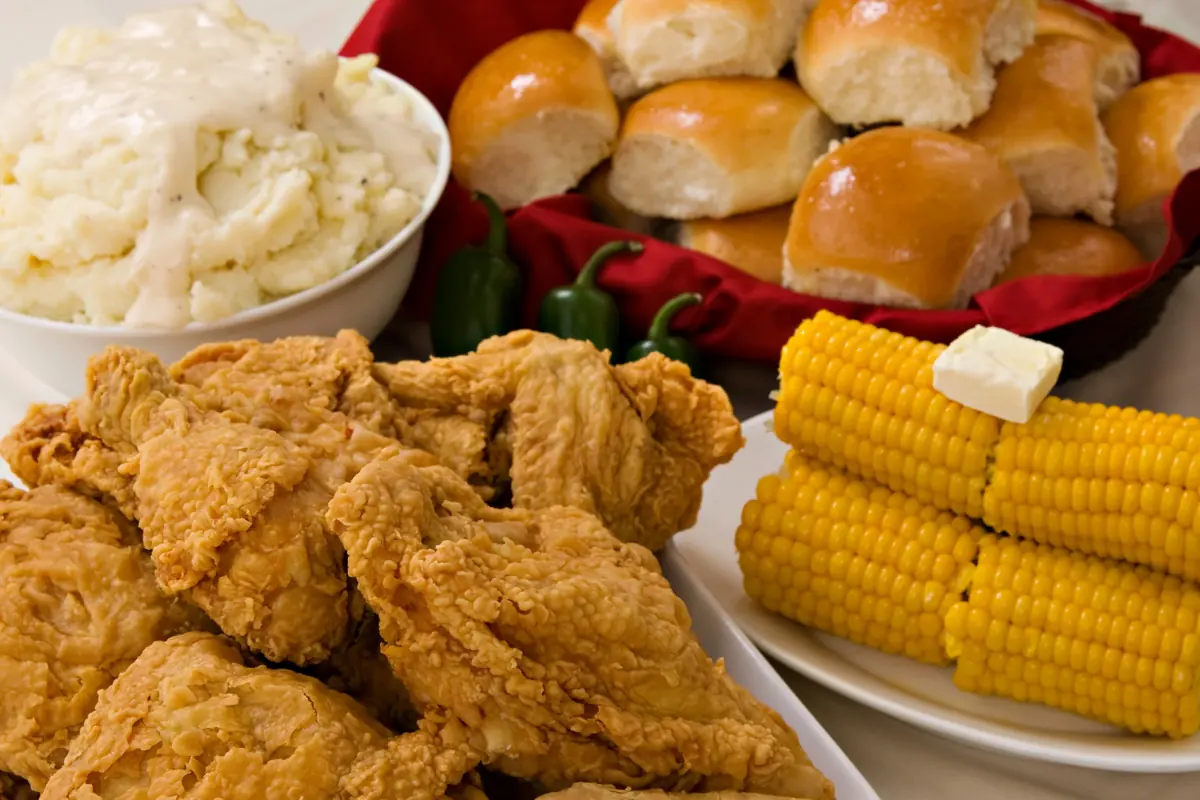 Fried chicken with mashed potatoes, corn and rolls